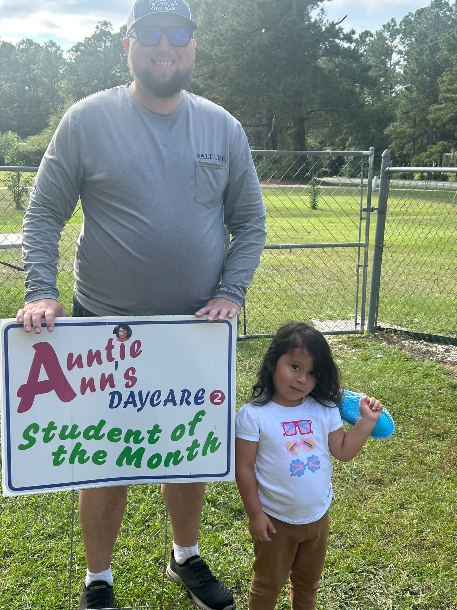 Amelia Faircloth beside Auntie Ann’s Student of the Month sign
